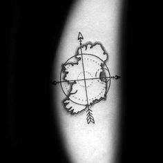 a black and white photo of a compass tattoo on the left arm with an arrow in it