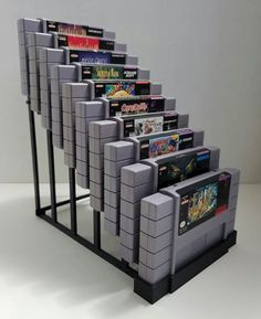 a bunch of nintendo game systems lined up in a row on top of each other