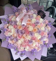 a bunch of flowers that are sitting in the back seat of a car on display