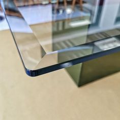 a glass table with some chairs in the background