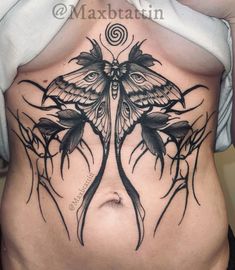 a woman with a butterfly tattoo on her stomach