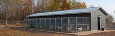 an image of a chicken coop in the middle of a field with trees and grass