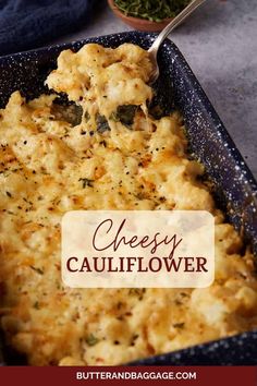 cheesy cauliflower casserole in a blue dish with a spoon