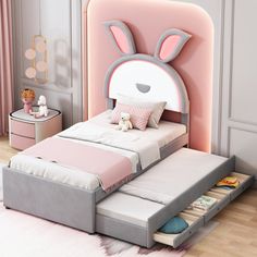 a child's bed with an animal head on it and drawers under the bed