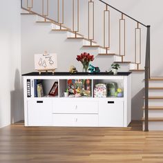 a white shelf with books and flowers on it in front of a stair case next to a hand rail