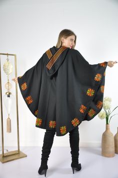 This vintage cape jacket is definitely a vintage fashion statement. It is 100% hand embroidered with geometrical patterns. It can be used over a jeans and shirt or sweater. Great to keep you warm. Please note that the capes we have at the moment (Option #1 and Option #2) are without a hoodie but they are just as beautiful and practical. Material : Wool Length : 49 inches Size : One size fits all. We ship your order with DHL express within one to two business days. Orders to Europe will typically Traditional Hooded Winter Poncho, Winter Embroidered Long Sleeve Poncho, Winter Festival Embroidered Poncho, Black Cape For Fall Festivals, Embroidered One-size Poncho For Fall, Black Fall Festival Cape, Embroidered Poncho For Fall, One Size, Embroidered One Size Poncho For Fall, One Size Embroidered Poncho For Fall