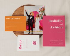 the wedding stationery is laid out on top of each other, including an orange and pink card