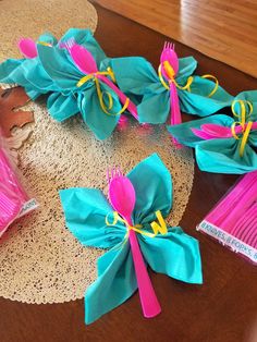 several pink and blue bows are tied together on a doily next to hairbrushes