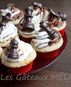 cupcakes with chocolate and white frosting on a red plate sitting on a wooden table