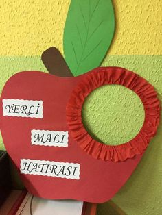 an apple shaped paper cutout with words written on it