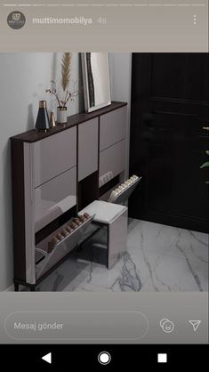 an image of a room with furniture and decor on the walls, including a dresser