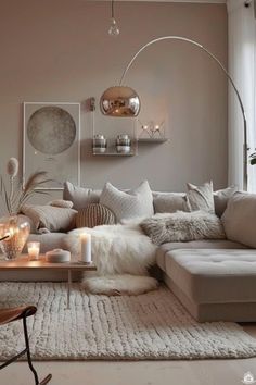 a living room filled with lots of furniture next to a large window on top of a rug