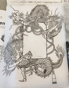 an open book with a drawing of a dragon on it