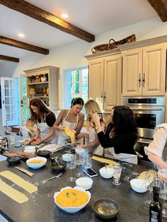 a group of people in a kitchen preparing food