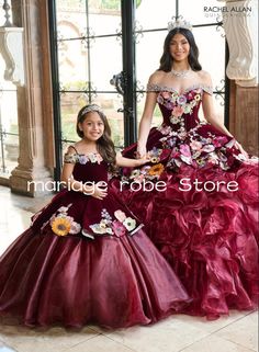 two girls in dresses standing next to each other wearing tiaras and gowns with flowers on them