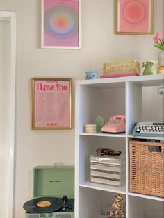 a white book shelf filled with lots of books and other things on top of it