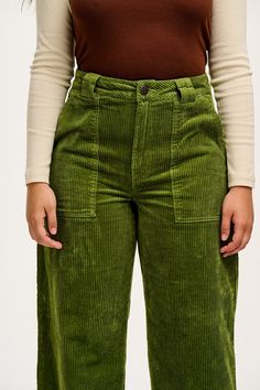 Delores Is Our High Waist Jeans With Wide Leg And Pockets With Stitching Detail. Available Here In Pesto Green! Our Fit Fixed Non-Stretch Waistband To Sit On The Waist With Fly Front And Button Closure Closer Fitting On The Hips Full Length Wide Leg Deep Hip Pockets And Back Patch Pockets The Fabric 100% Organic Cotton Corduroy - Made From Gots Certified Organic Cotton Yak Care Machine Washable We Advise Using A Laundry Bag To Protect The Cord Pile. It Will Also Prevent Creasing As Much Line Dry Wide Wale Corduroy Pants, Full Length Green Corduroy Bottoms, Green Corduroy Bottoms With Pockets, Green Corduroy Levis, Green Full-length Corduroy Pants, Lucy Yak, Lucy And Yak, Corduroy Jeans, Corduroy Trousers