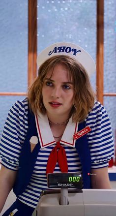 a woman wearing a sailor's outfit and hat