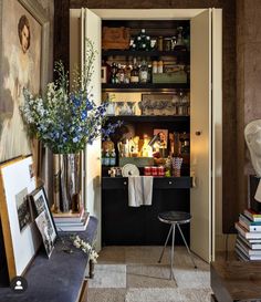 a living room filled with furniture and lots of books