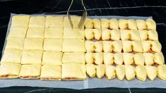 there are many square pastries on the table ready to be cut into squares and put together