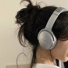 a woman with headphones on her ears