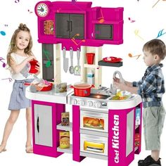 two children are playing with a toy kitchen