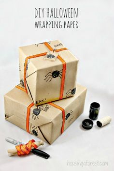 three wrapped boxes with halloween decorations on them