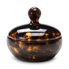 a tortoise shell covered jar with a lid