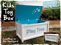 a blue and white toy box sitting on top of a grass covered field next to a brick wall