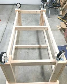 an unfinished bed frame being assembled in a garage