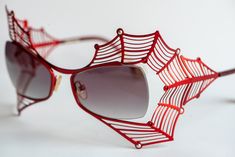 Boz Scandale Spider Web sunglasses in red color decorated with red and silver stones. This model has been discontinued by the manufacturer and is very rare now.  Boz Scandale 3333 52◻18 121 Patented design Made in France 100% Authentic Condition: Very good pre-owned condition. No signs of wear, no scratches on the lenses. There is just one very little chipped place on the right lens. Please carefully check the last photo. I made it with macro camera. It can't be easily noticed and you can't feel it when you wear the glasses.  Dimensions:  Overall Width: 138 mm = 5.43 in  Lens Width: 52 mm = 2.05 in Lens Height: 34 mm = 1.34 in Temple Length: 121 mm = 4.76 in Nose Bridge: 18 mm = 0.71 in The glasses will be sent in their original glasses case (however it's peeled off because of time) with a Luxury Red Sunglasses For Party, Luxury Red Sunglasses For Formal Occasions, Red Sunglasses For Summer Formal Events, Red Sunglasses For Formal Summer Events, Elegant Red Sunglasses For Formal Occasions, Formal Red Sunglasses For Summer, Spider Sunglasses, Decorated Sunglasses, Glasses Inspo