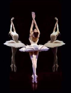 three ballerinas in white tutus and ballet shoes, with their arms stretched out