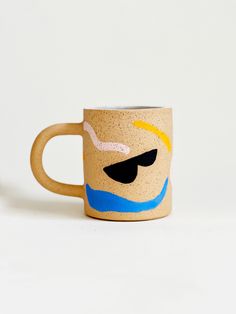 a coffee cup with a face painted on it