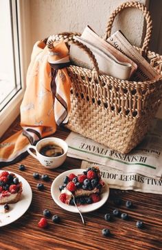 two small plates with food on them next to a basket filled with books and magazines