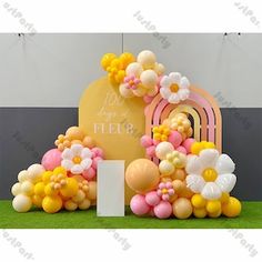 an arrangement of balloons and flowers in front of a sign