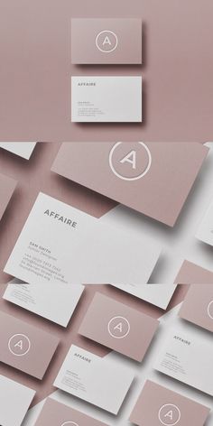 some white and pink business cards on top of each other with the letter a in the middle