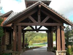 a wooden gazebo sitting in the middle of a park