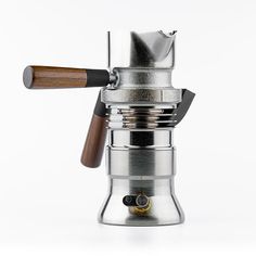 an espresso machine with a wooden handle on the top and bottom, in front of a white background