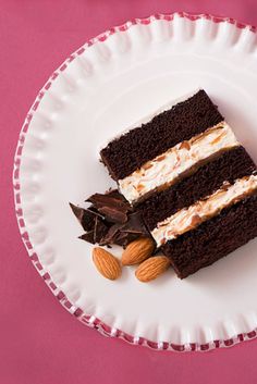 a piece of cake on a plate with almonds