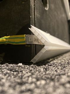 an origami paper airplane sitting on the floor