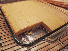 a cake in a glass baking dish on a rack