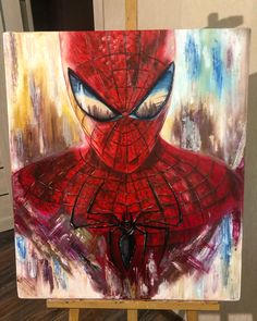 a painting of a spider man on an easel