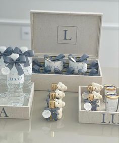 a table topped with two boxes filled with water bottles and small teddy bear figurines