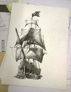 a drawing of a ship on top of some papers