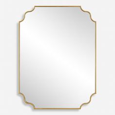 a gold framed mirror on a white wall