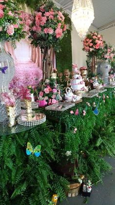 there are many flowers and plants on the wall in this room that is decorated with pink roses