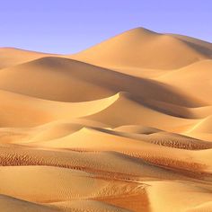 sand dunes in the desert with blue sky