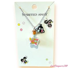 a necklace with an image of a cat and some other animals hanging from it's back