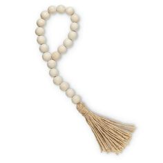 a white beaded necklace with tassels and a wooden cross on the end