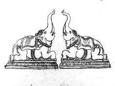 two elephants standing next to each other on top of a table